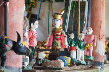 Fototapeta na wymiar Common Vietnamese water puppets behind puppetry state. The control room is dark to hide puppeteers and instruments