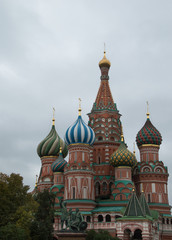 Fototapeta na wymiar St. Basil's Cathedral with its decorative red brick facade and colorful onion domes topped with crosses. Located on Red Square in Moscow.