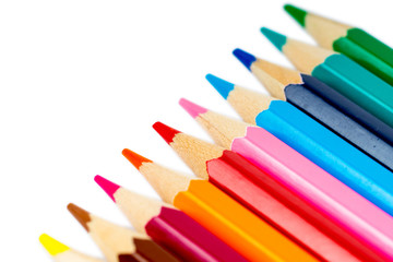 Obraz premium Close-up of colorful pencils in line on white background