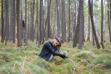 Beautiful young girl walking in the autumn forest.