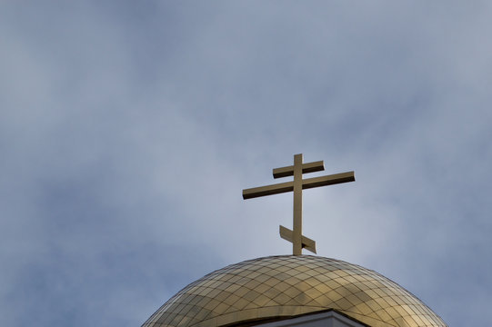 Close Up of Dome on Church of All Saints with the Orthodox cross on top, against a blue sky. The church was built on the execution site of the Romanov family in Yekaterinburg.