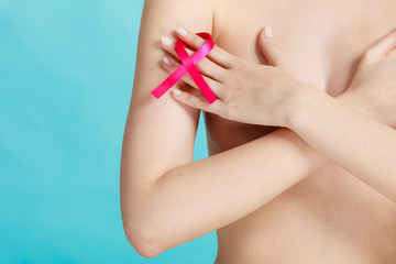 Naked woman with breast cancer awareness ribbon