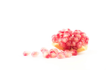Ripe pomegranates with leaves isolated on a white background.