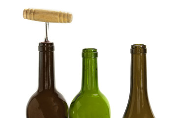 Wine bottles, one of them corked, on white