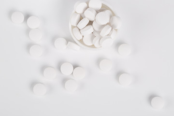 Round white pills on the white background