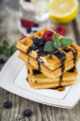 Belgian waffles with raspberries, blueberries and mint, covered