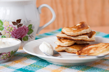 Delicious pancakes with sour cream for breakfast