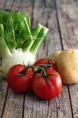 Fennel, tomatoes and potatoes on a wooden table1