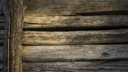wall of old planks of building a barn to store hay in a farmhouse