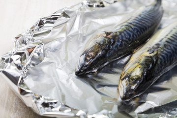 Raw mackerel in foil close up. Preparation of fresh fish.