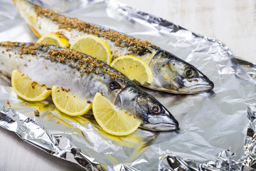Raw mackerel in foil close up. Preparation of fresh fish.