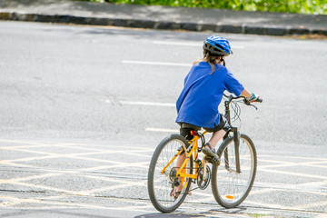 Naklejka premium young happy preteen child boy riding a bicycle on natural park b