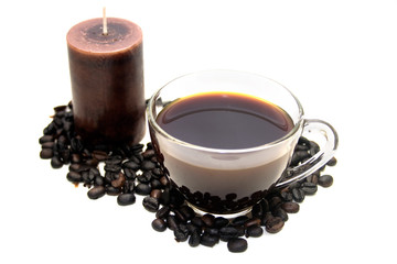 Cup of coffee candle and coffee beans on white background
