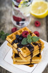 Belgian waffles with raspberries, blueberries and mint, covered
