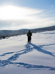 Fototapeta na wymiar Hiker in winter in mountains