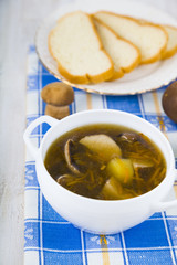 Soup of wild mushrooms on a wooden table