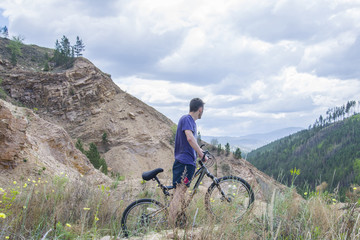 Fototapeta premium Young man on mountain bike in the mountains.