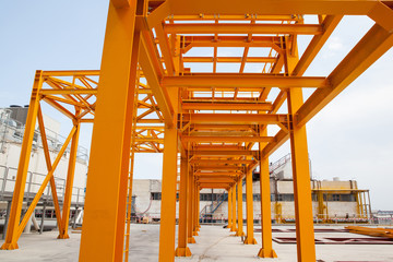 Yellow steel construction in open at factory.