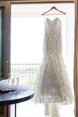 Modern white wedding dress at the window