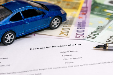 document - buying a car with euro, pen, calculator and toy car.