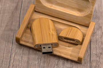 Wooden flash drive on wooden table.
