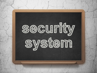 Protection concept: Security System on chalkboard background