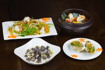 Set of Asian seafood with grilled geoduck with onion and grease, Coconut Escargot, Shrimp stir-fried vermicelli, Spicy steam clam