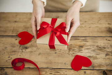 The woman is giving a gift