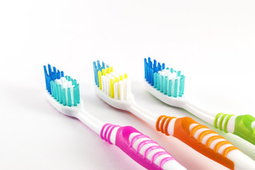 Multicolor toothbrushes closeup on white background