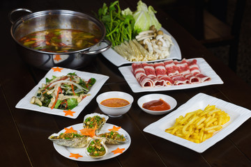 Set of Asian food with Fried Crispy Potato, Barbecue geoduck with onion and grease, Shrimp stir-fried vermicelli, hot pot with raw beef slide