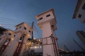Floodgate with Bhumibol bridge in Thailand at night.