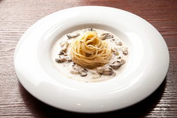 oyster cream pasta on white plate