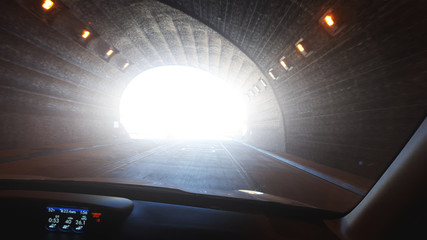 photo inside from the car on light at the end of tunnel