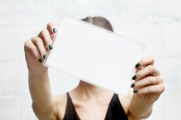 Woman showing white blank paper