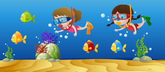 Naklejka na ściany i meble Two girls diving under the ocean