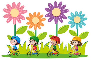 Obraz na płótnie Canvas Kids riding bicycle in garden.