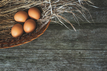 chicken eggs on old wooden table, rustic background