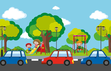 Scene with children in playground and cars on the road