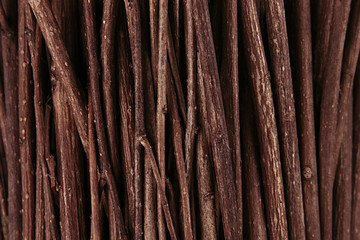 Thin brown dark wooden branches top view, wood background.