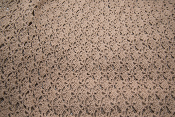 Brown sweater knitted in manual photographed in close-up.