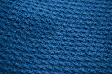 Blue top knitted in manual photographed in close-up.