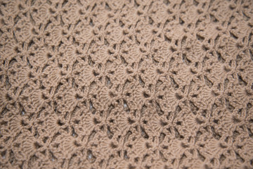 Brown sweater knitted in manual photographed in close-up.