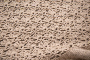 Brown sweater knitted in manual photographed in close-up.