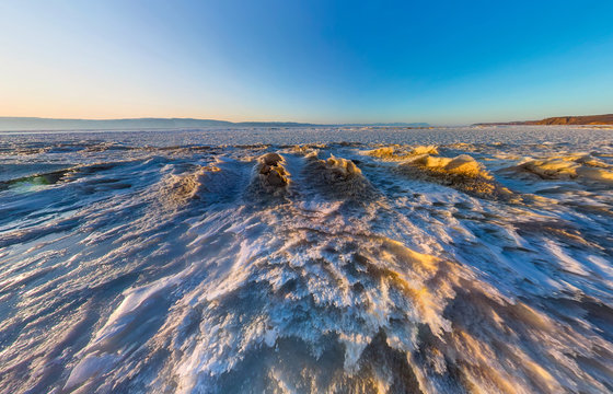 Aerial panorama of snow sunrise wave on the shore of Olkhon. Bai