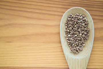 Buckwheat on the wooden board. Healthy eating and lifestyle.