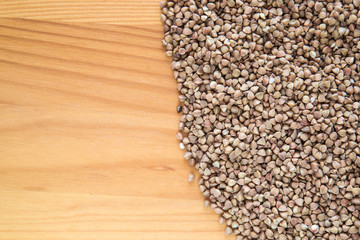 Buckwheat on the wooden board. Healthy eating and lifestyle.