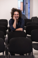 A student sits alone  in a classroom