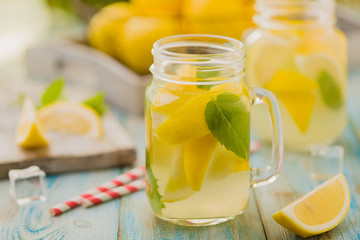 lemonade with mint on rocks served in jar with a straw