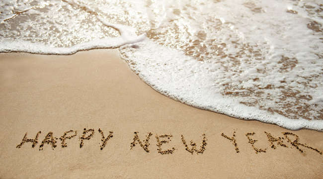 Happy new year on the sand beach - Powered by Adobe