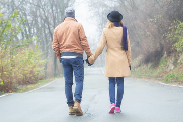 Young couple walking outdoors.